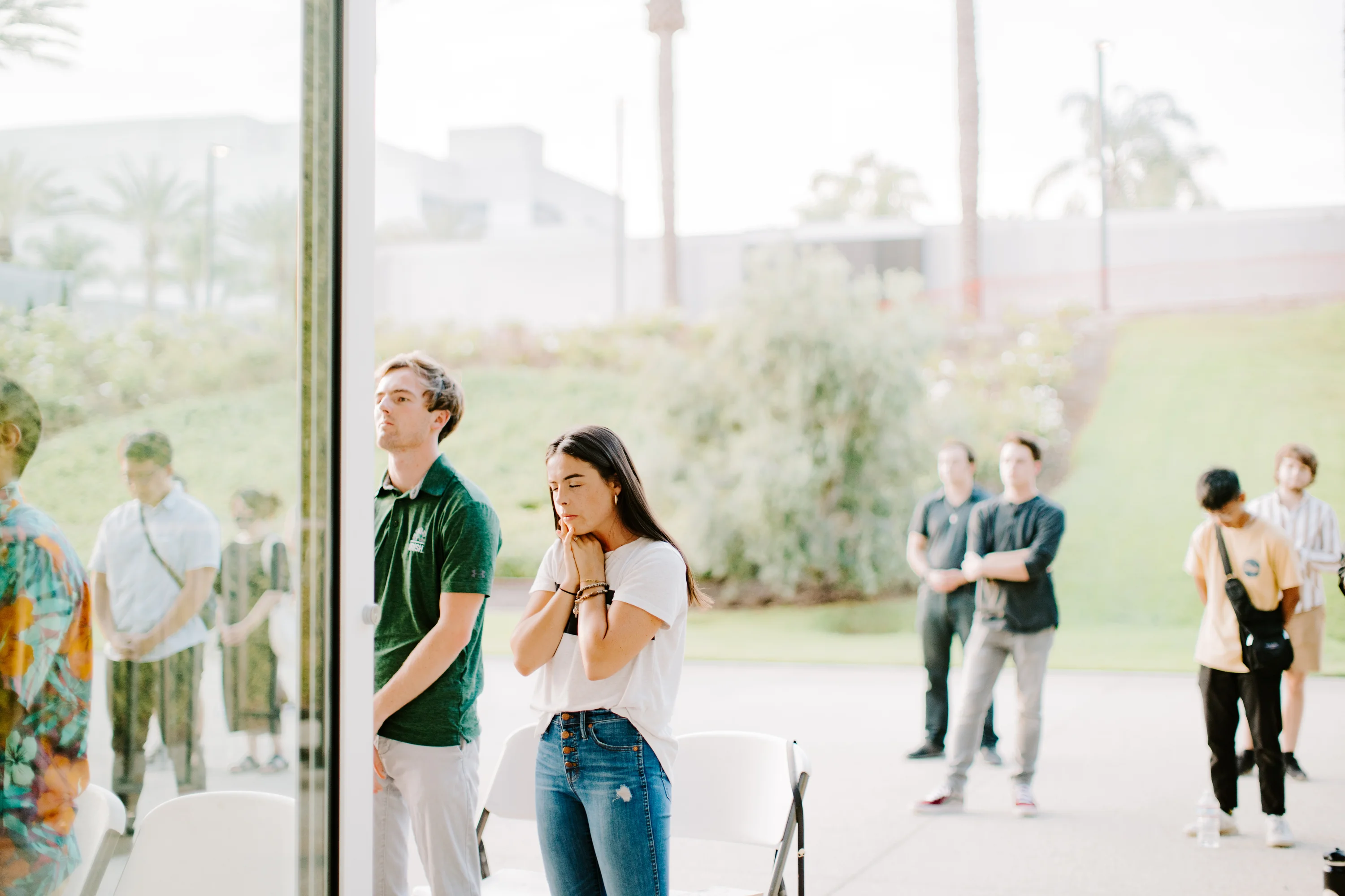 Young adults standing in prayer